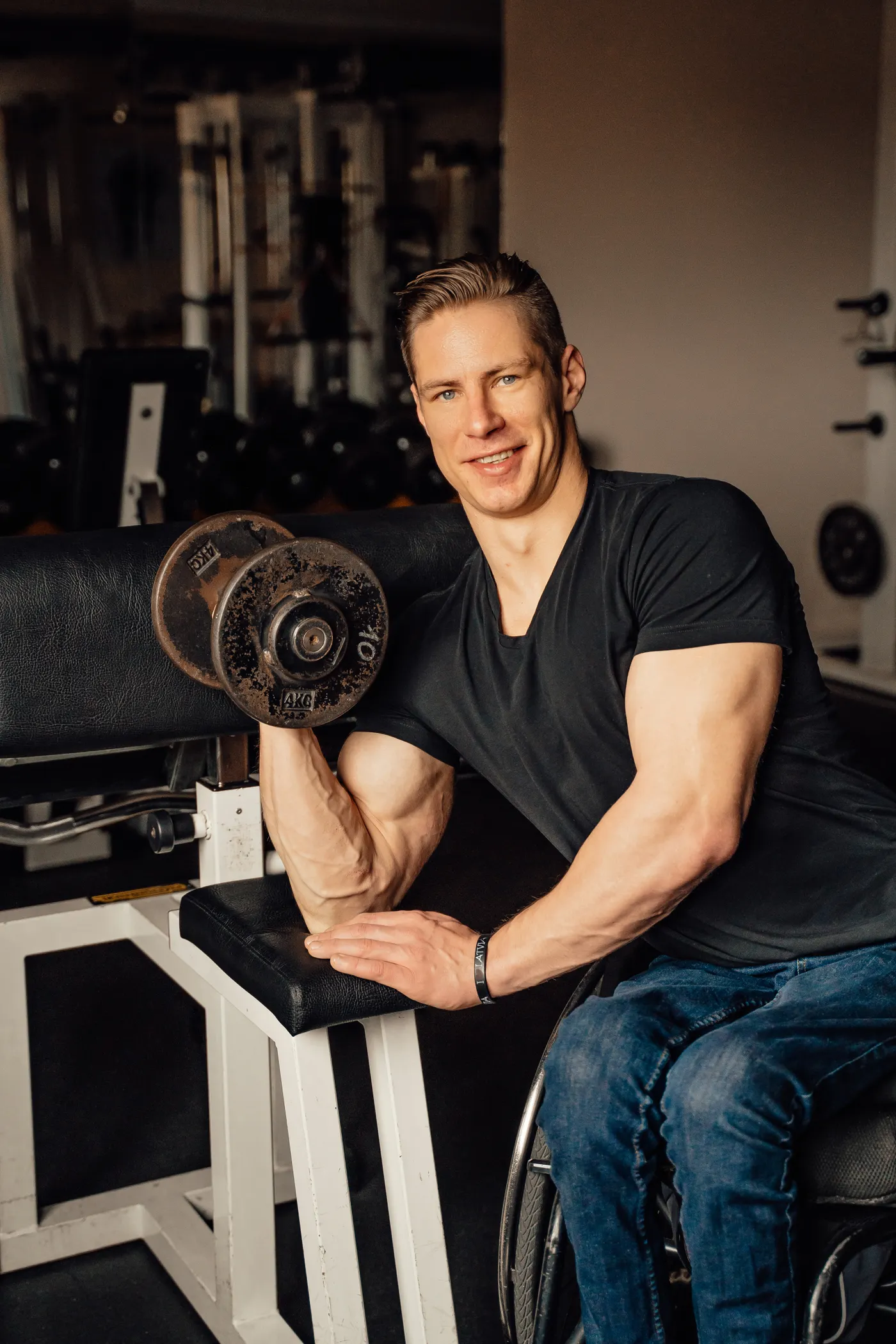 Lifter performing a direct biceps curl with a dumbbell