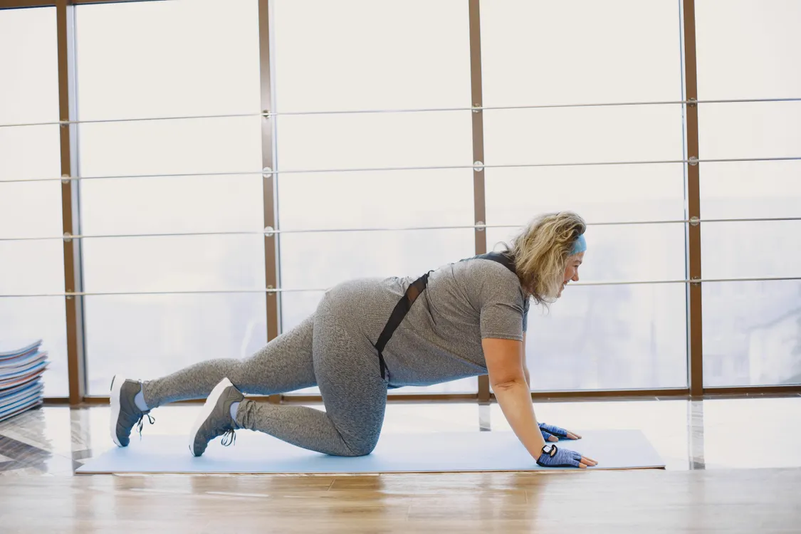 Woman using resistance bands for a controlled indoor home workout
