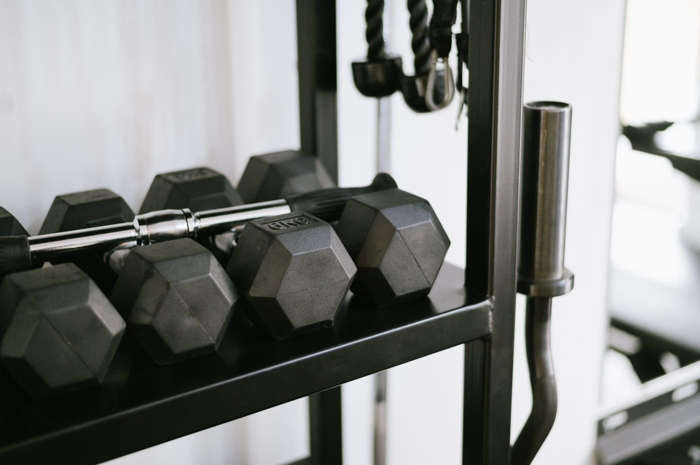 Dumbbells stored on a rack in a gym