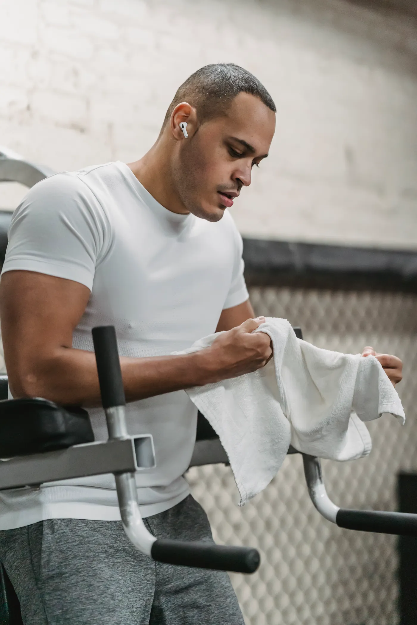 Athlete wiping sweat with a towel during a gym break