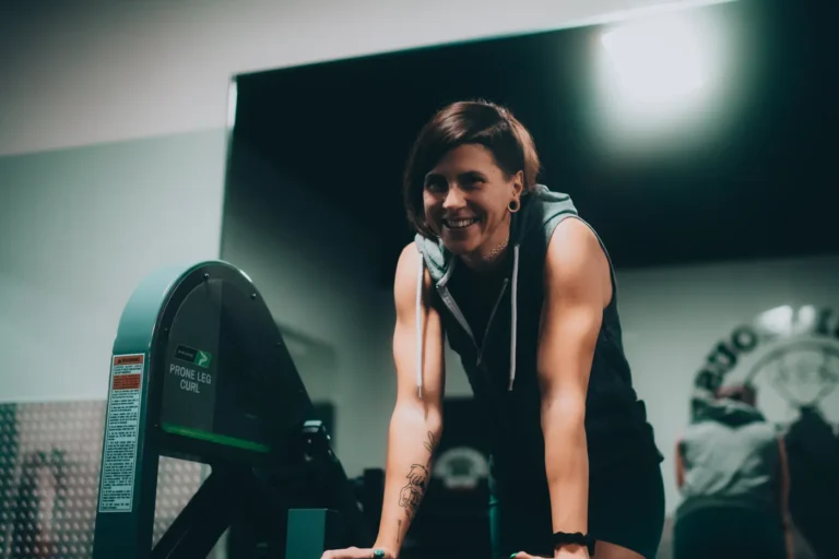 Woman using a leg curl machine during a gym workout