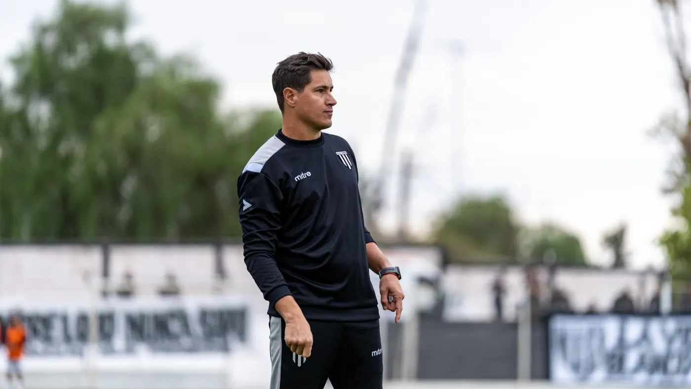 Soccer coach observing a field training session