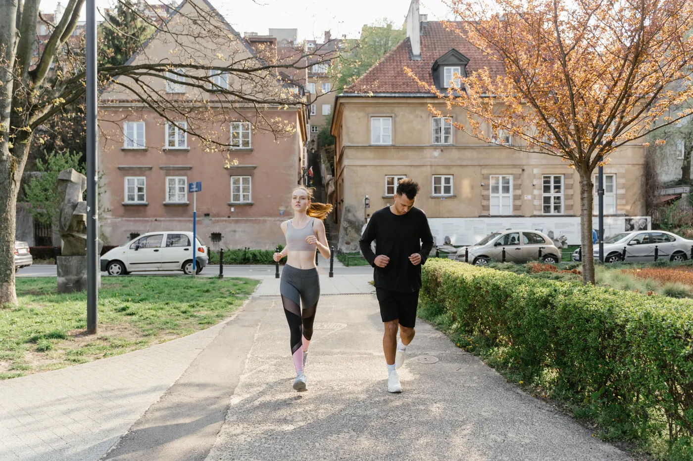 Couple jogging together in a neighborhood park