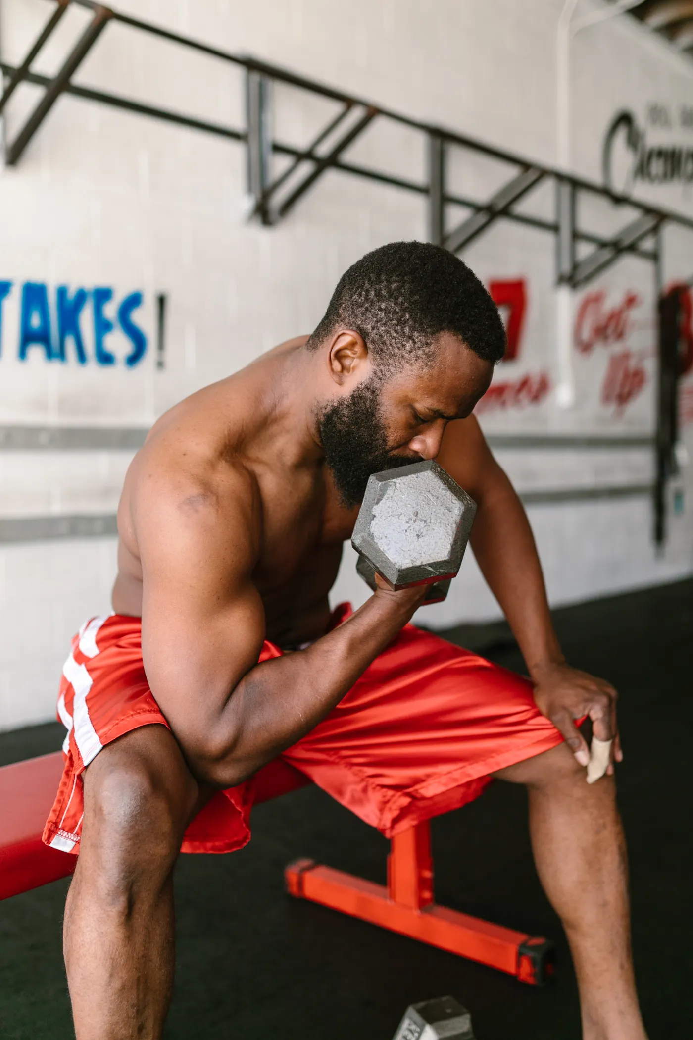 Man performing a controlled dumbbell curl during a workout