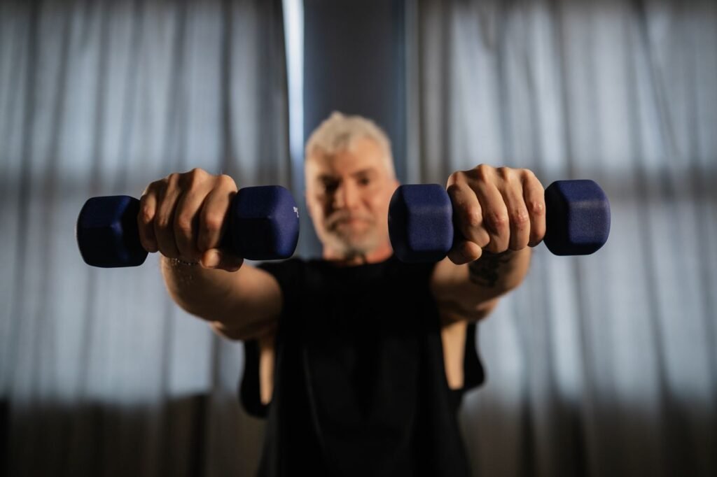 Senior man lifting dumbbells as part of a strength training routine