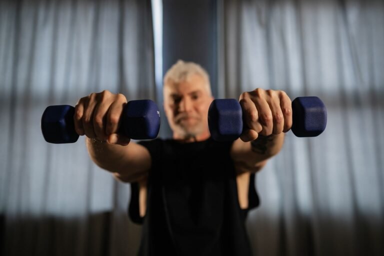 Senior man lifting dumbbells as part of a strength training routine