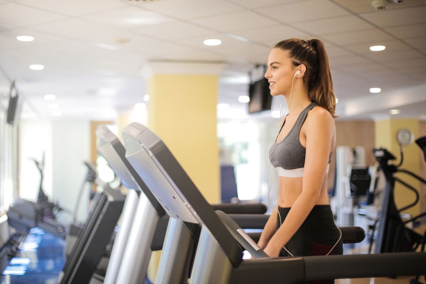 Woman using a treadmill during an indoor cardio session