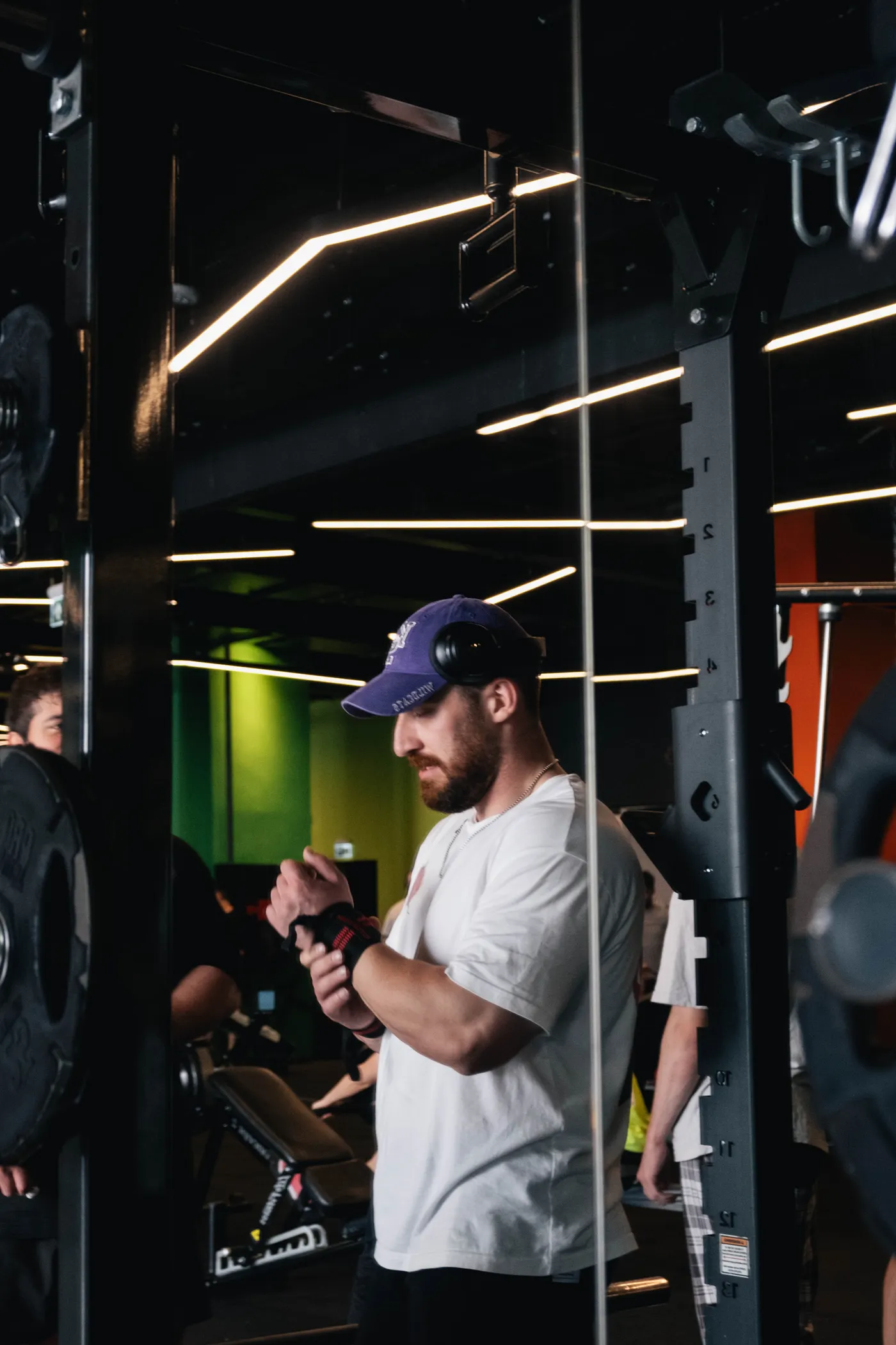 Athlete adjusting wrist wraps before a weight-training session