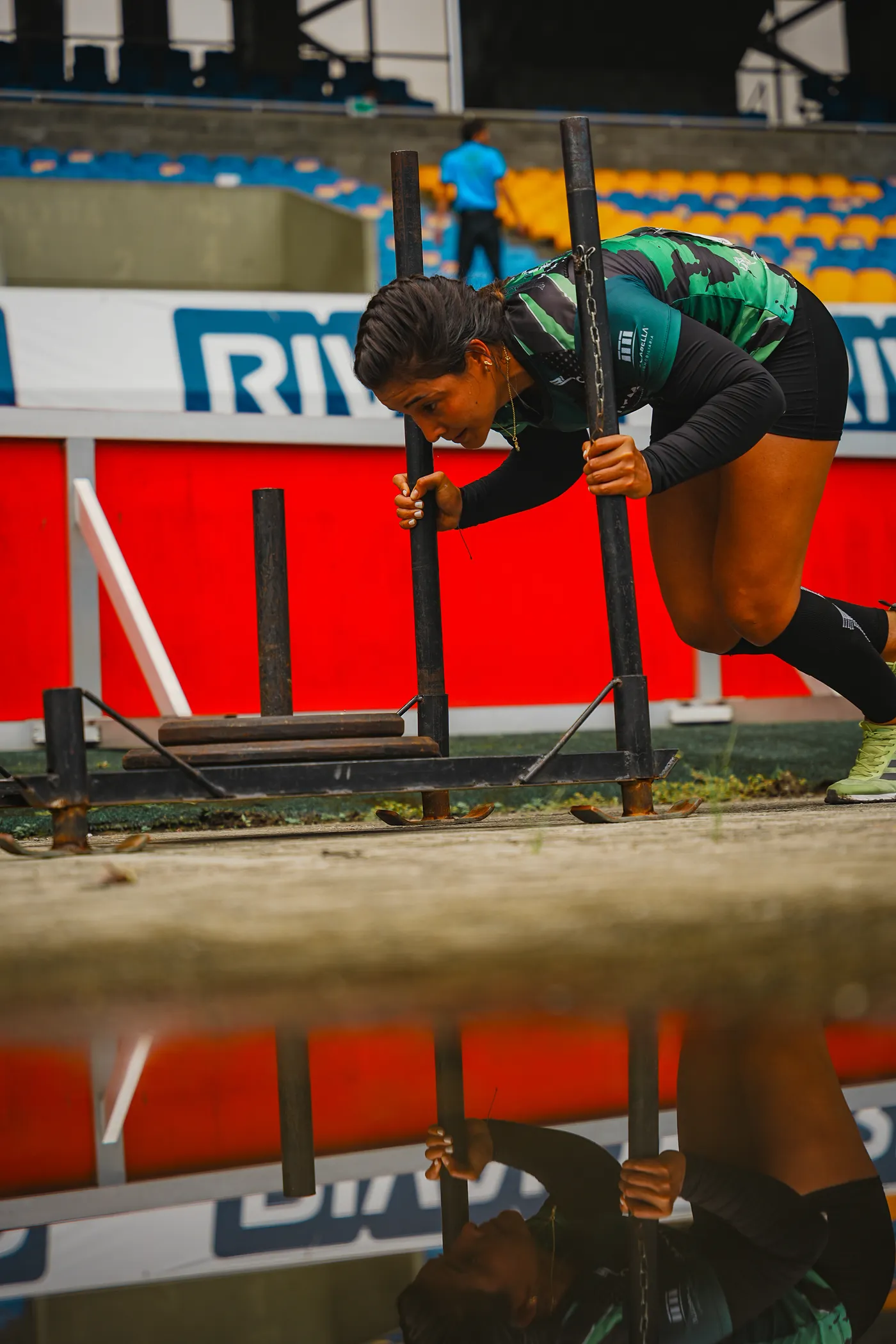 Athlete pushing a sled on an outdoor training surface