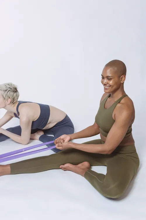 Two women performing resistance band exercises