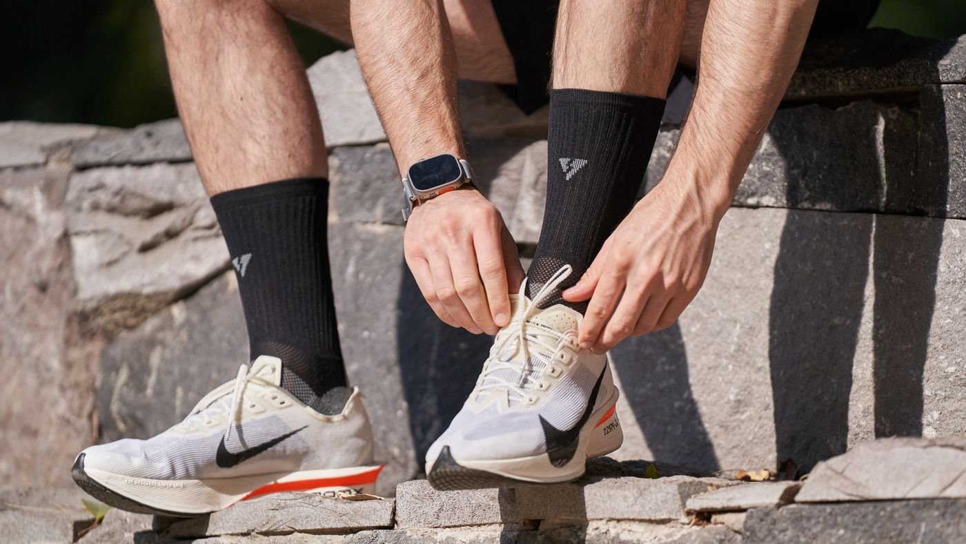 Runner tying shoes on outdoor steps before training