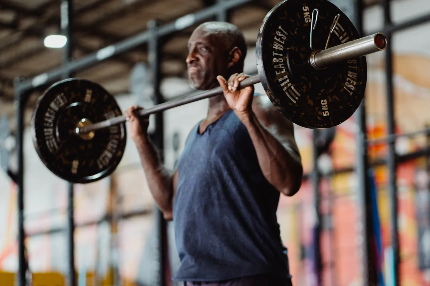 Man lifting a barbell in a gym during resistance training