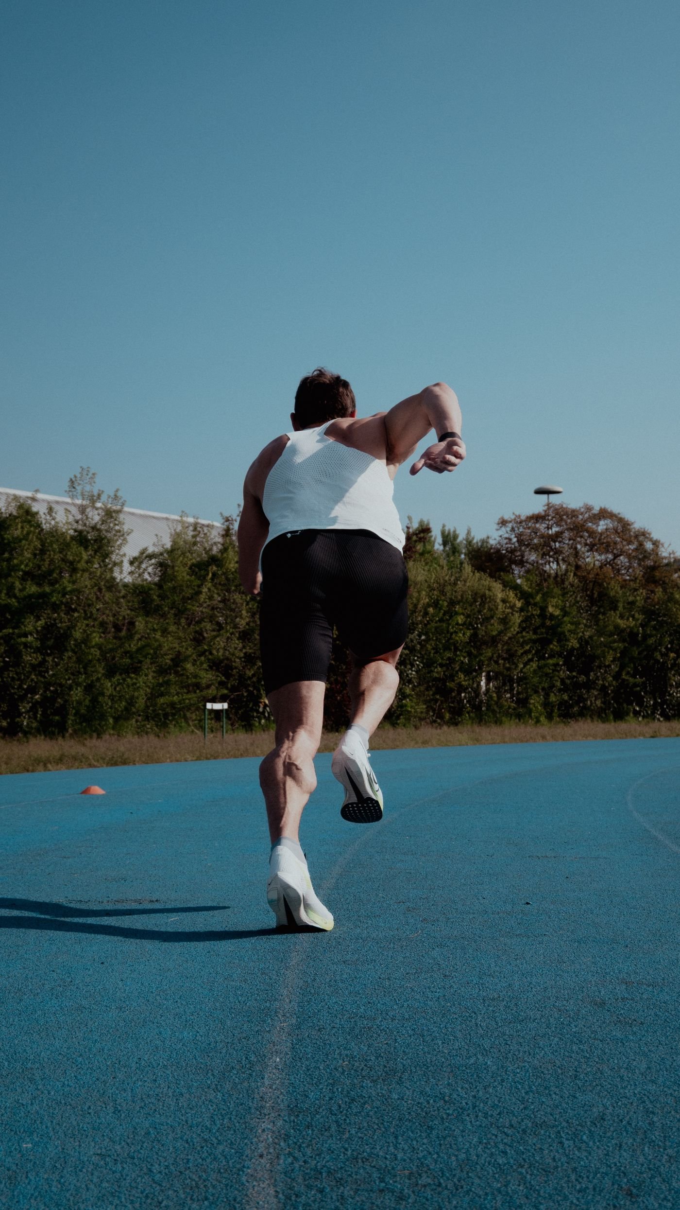 Sprinter accelerating on an outdoor athletics track