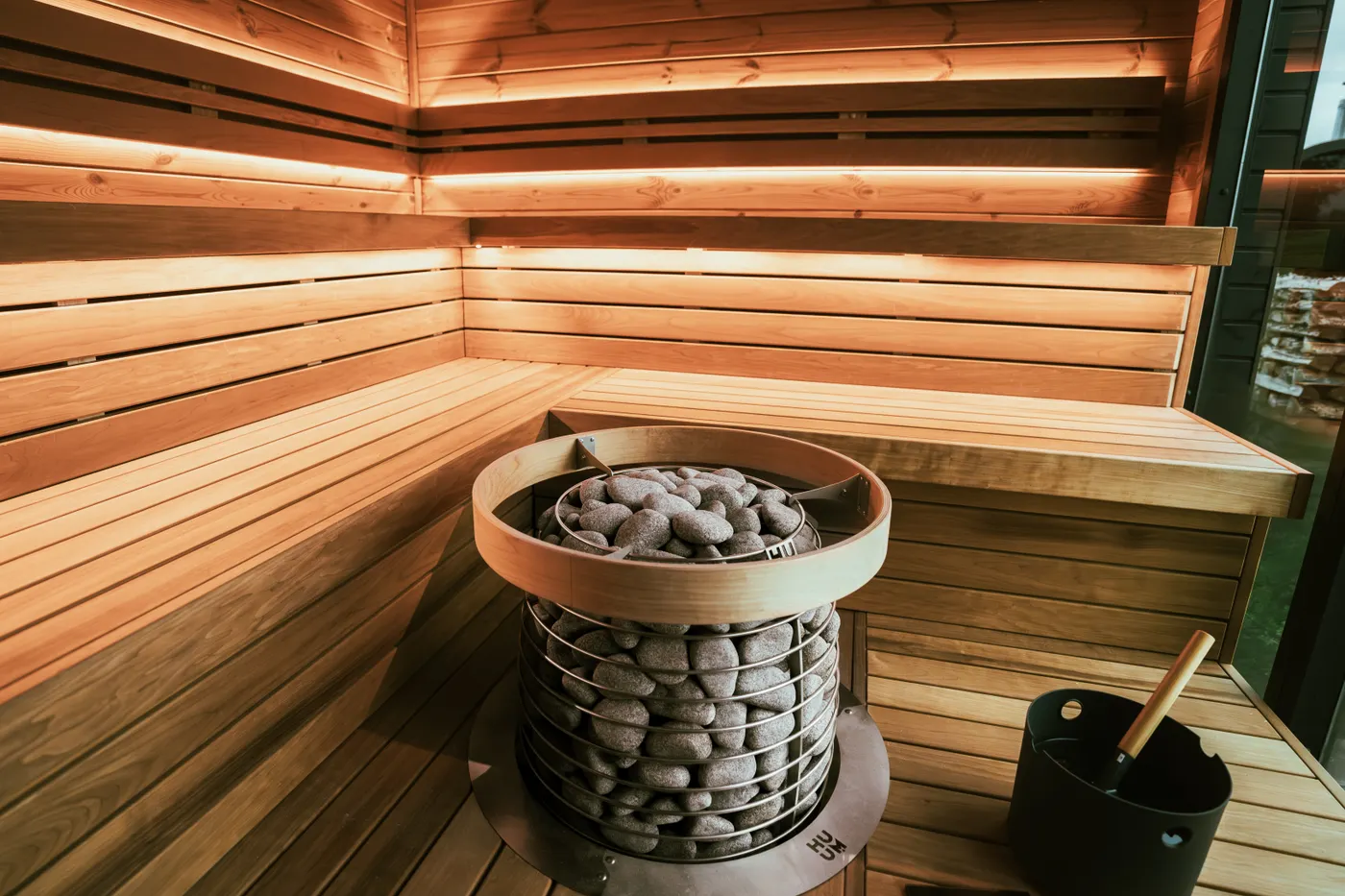 Close-up of a modern sauna heater and hot stones