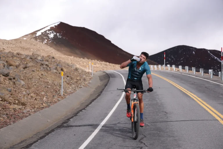 Road cyclist drinking from a bottle on a mountain ride