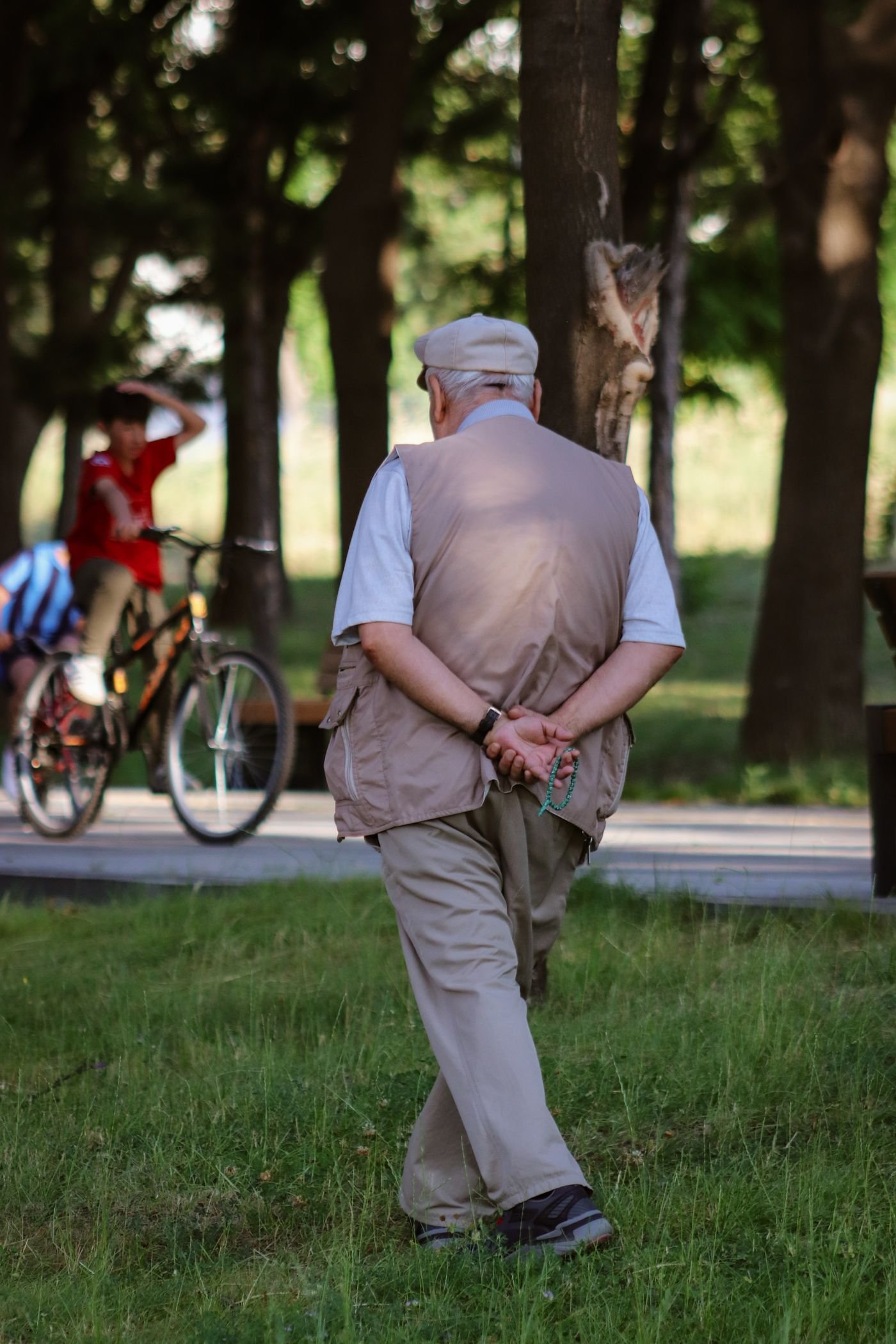 Senior man walking in a peaceful green park