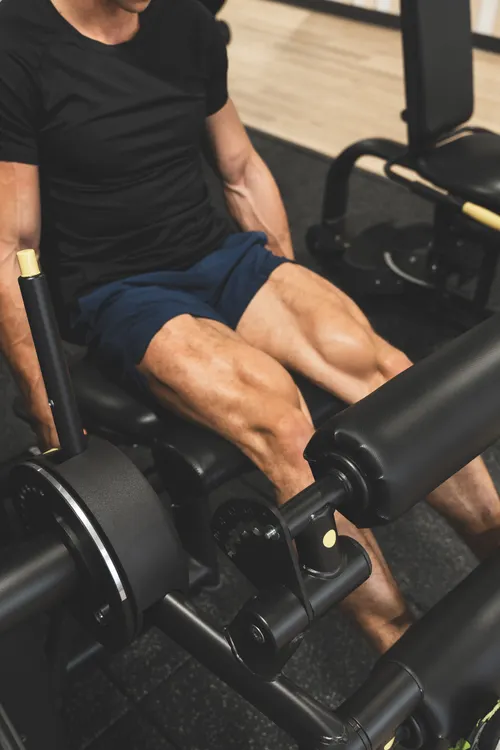 Man performing leg-press repetitions on a resistance machine