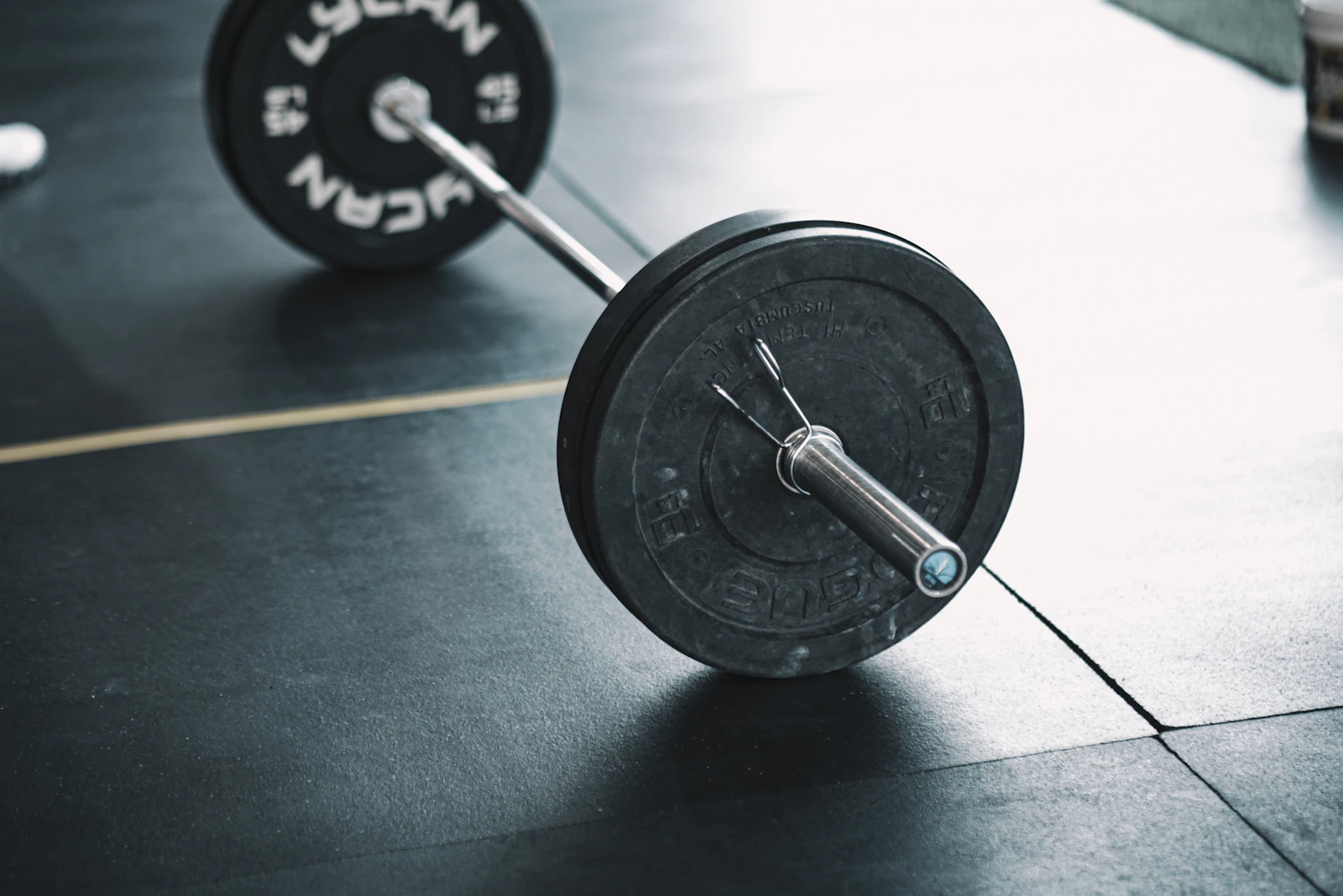 Loaded barbell resting on a gym floor