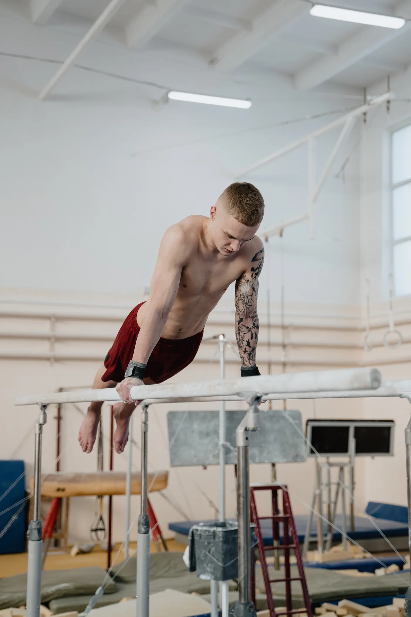 Gymnast controlling his body position on parallel bars