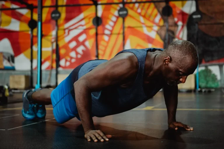 Man performing a floor push-up during a gym workout