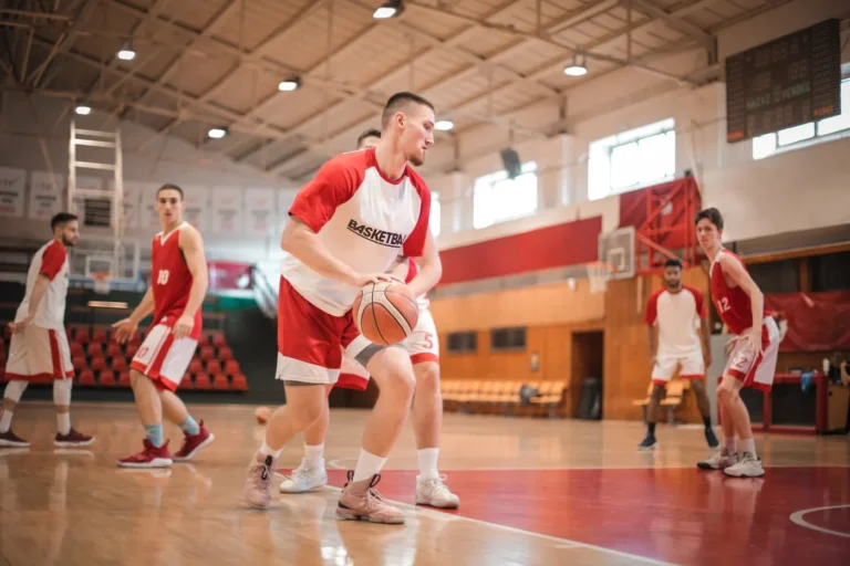 Male basketball players practicing together on an indoor court