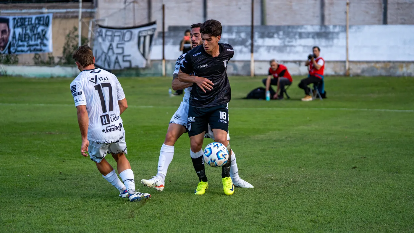 Two soccer players competing for the ball during a match