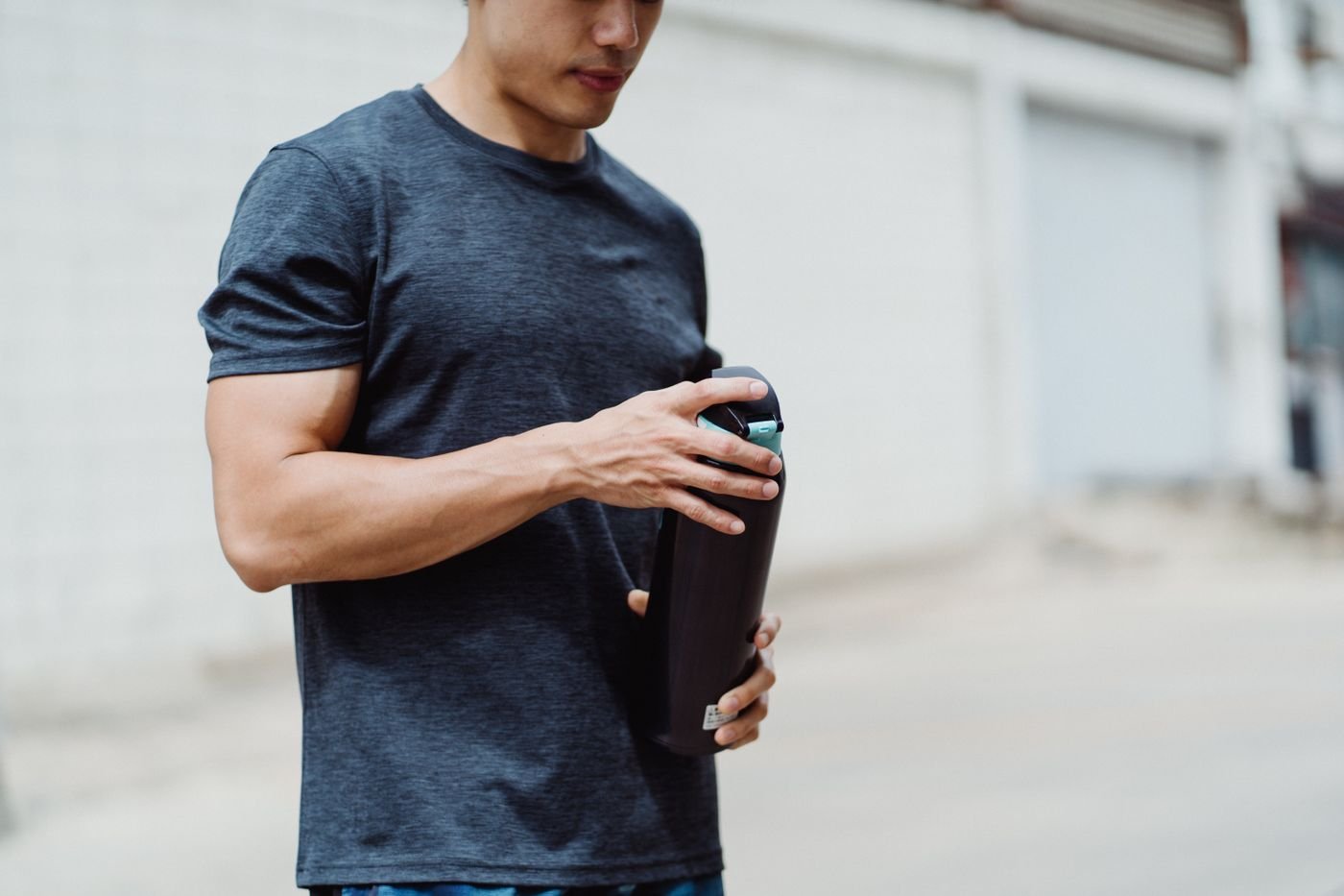 Athlete holding a water bottle during exercise recovery