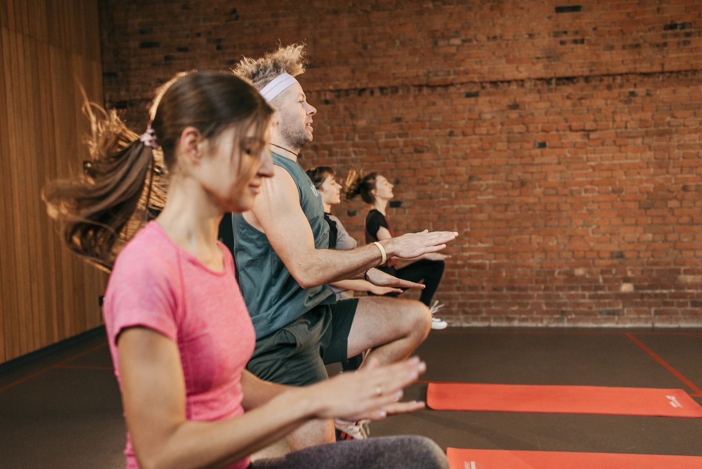 People taking part in an indoor group fitness class