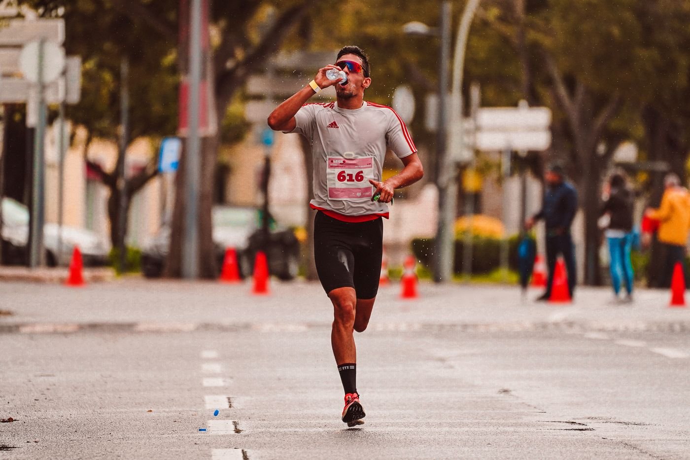 Runner drinking water during a long road race