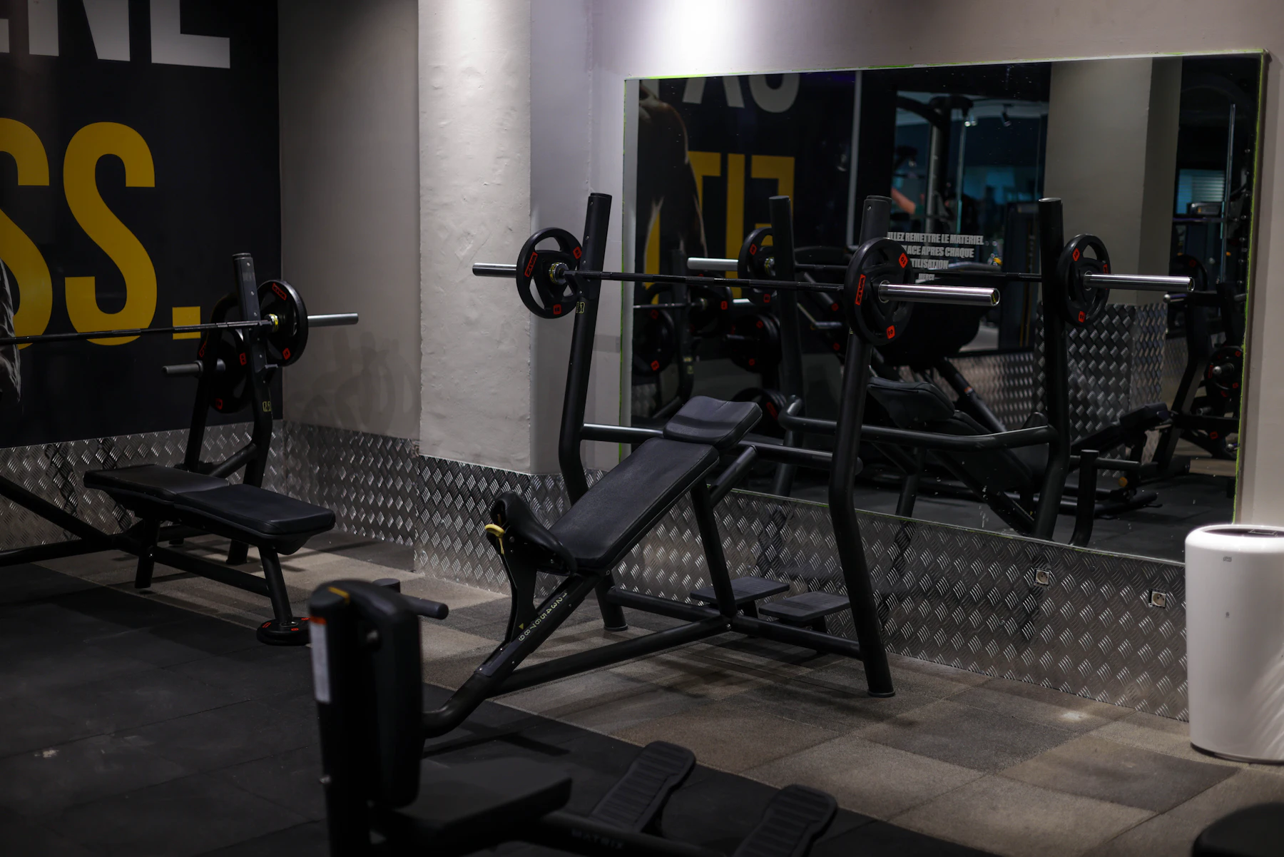 Bench press station and equipment inside a gym