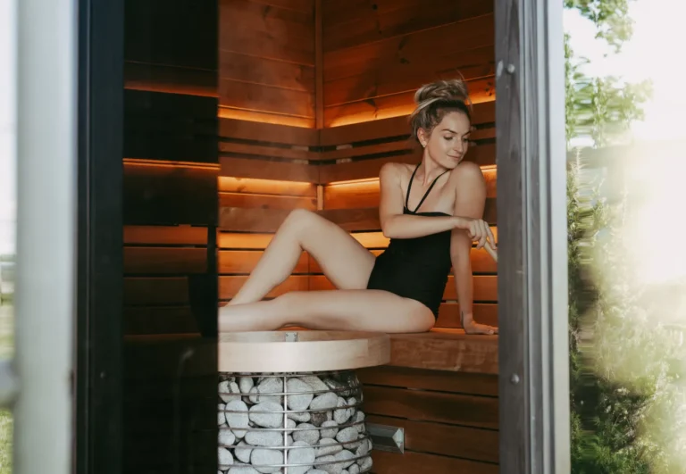 Woman relaxing inside a warm wooden sauna after exercise