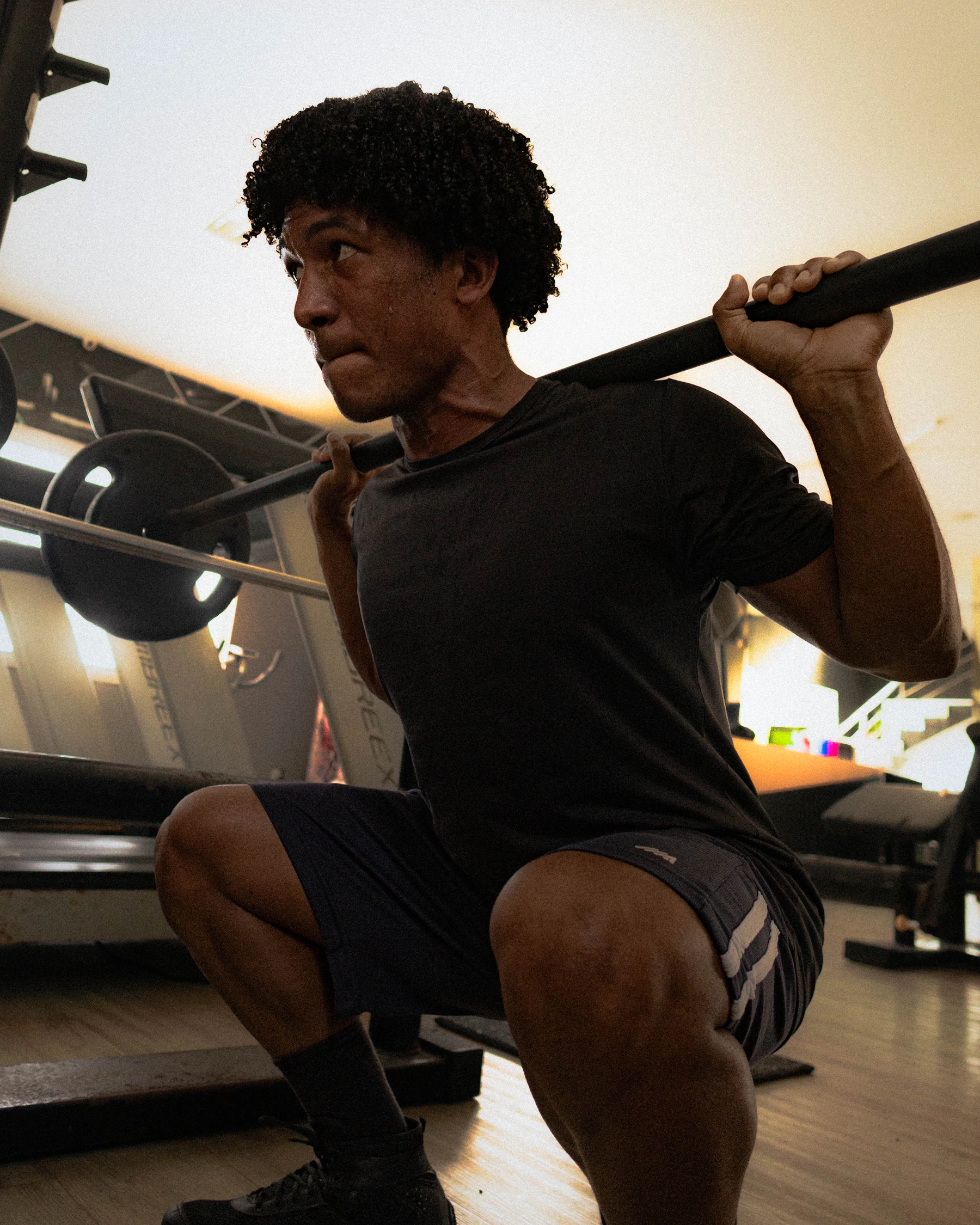 Athlete performing a barbell squat for progressive strength training