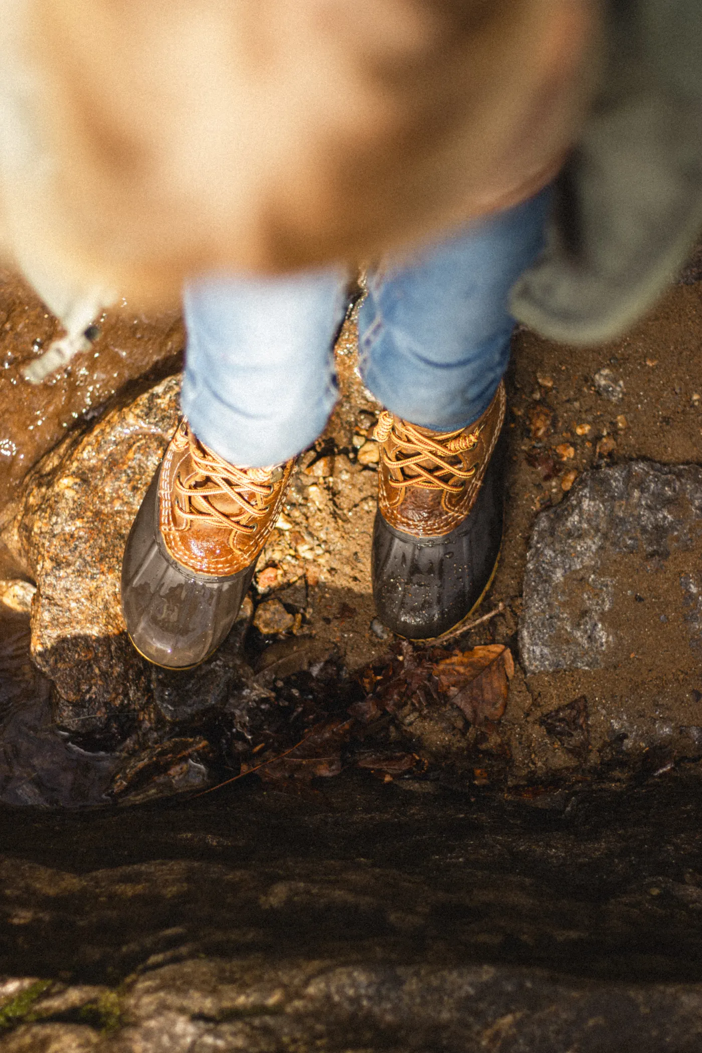Close-up of hiking boots standing on rocky ground