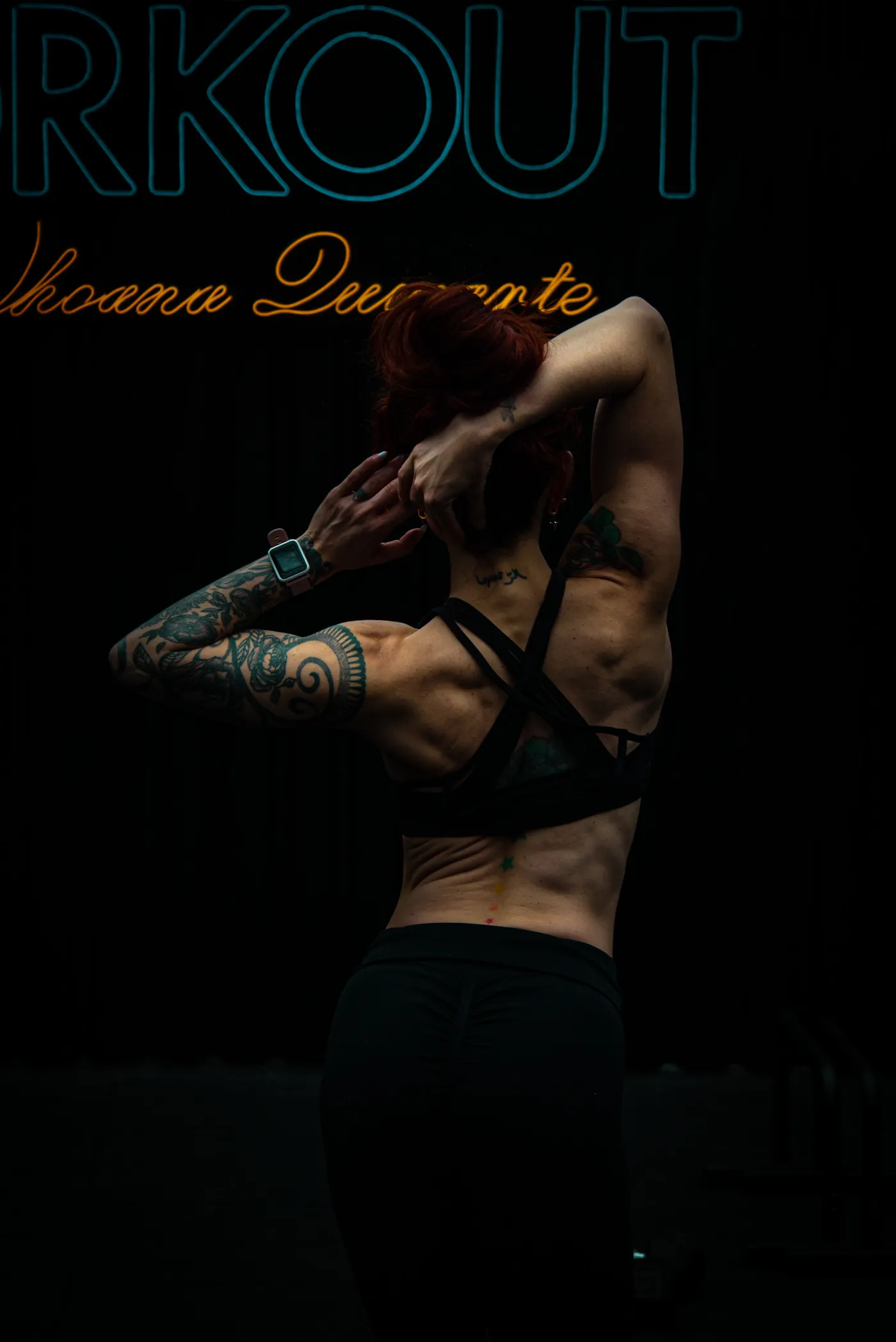 Back view of an athlete stretching her shoulders