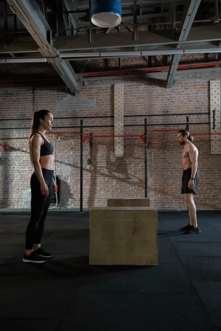 Athletes preparing to jump onto plyometric boxes in a spacious gym
