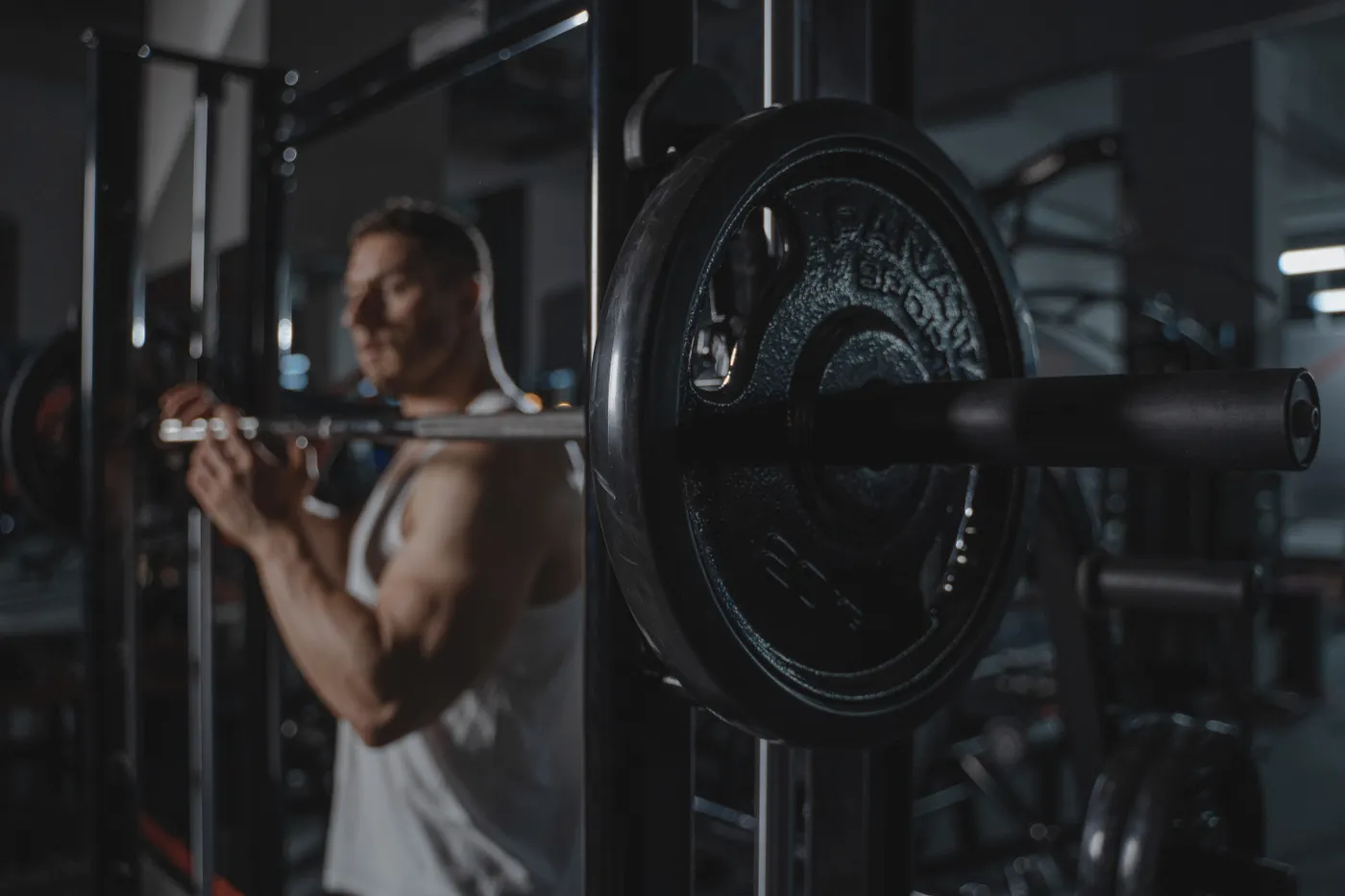 Athlete lifting a loaded barbell in a strength-training gym