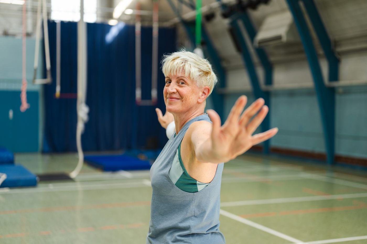 Active senior woman stretching in a gymnasium