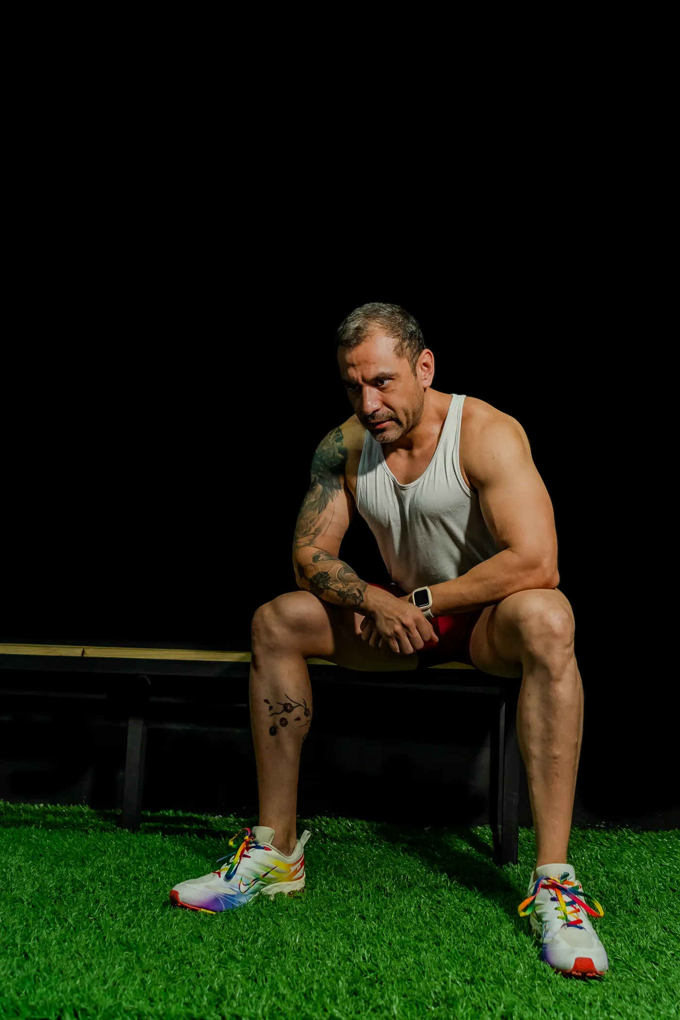 Athlete resting on a bench between demanding gym sessions