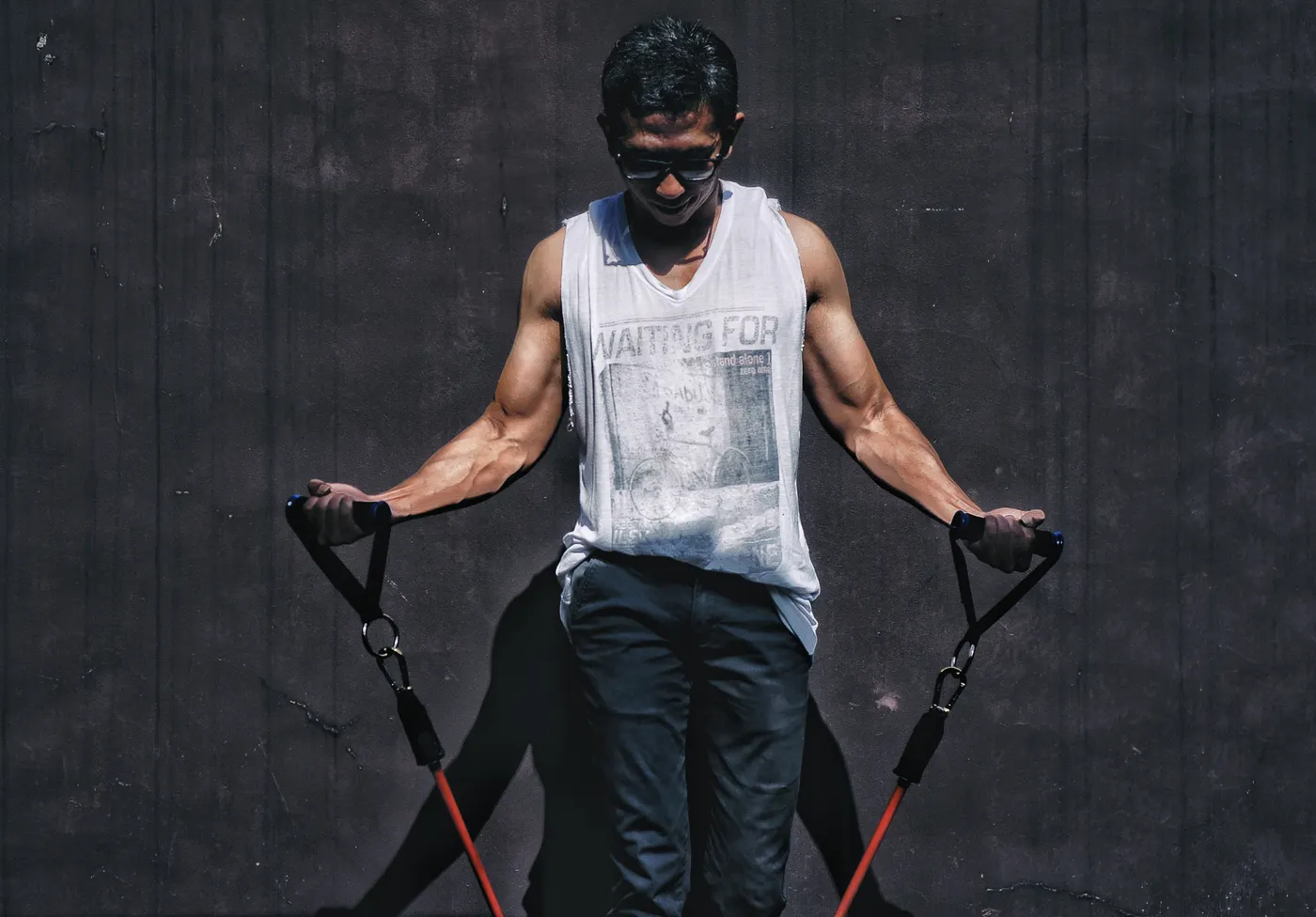 Athlete training with elastic resistance bands outdoors
