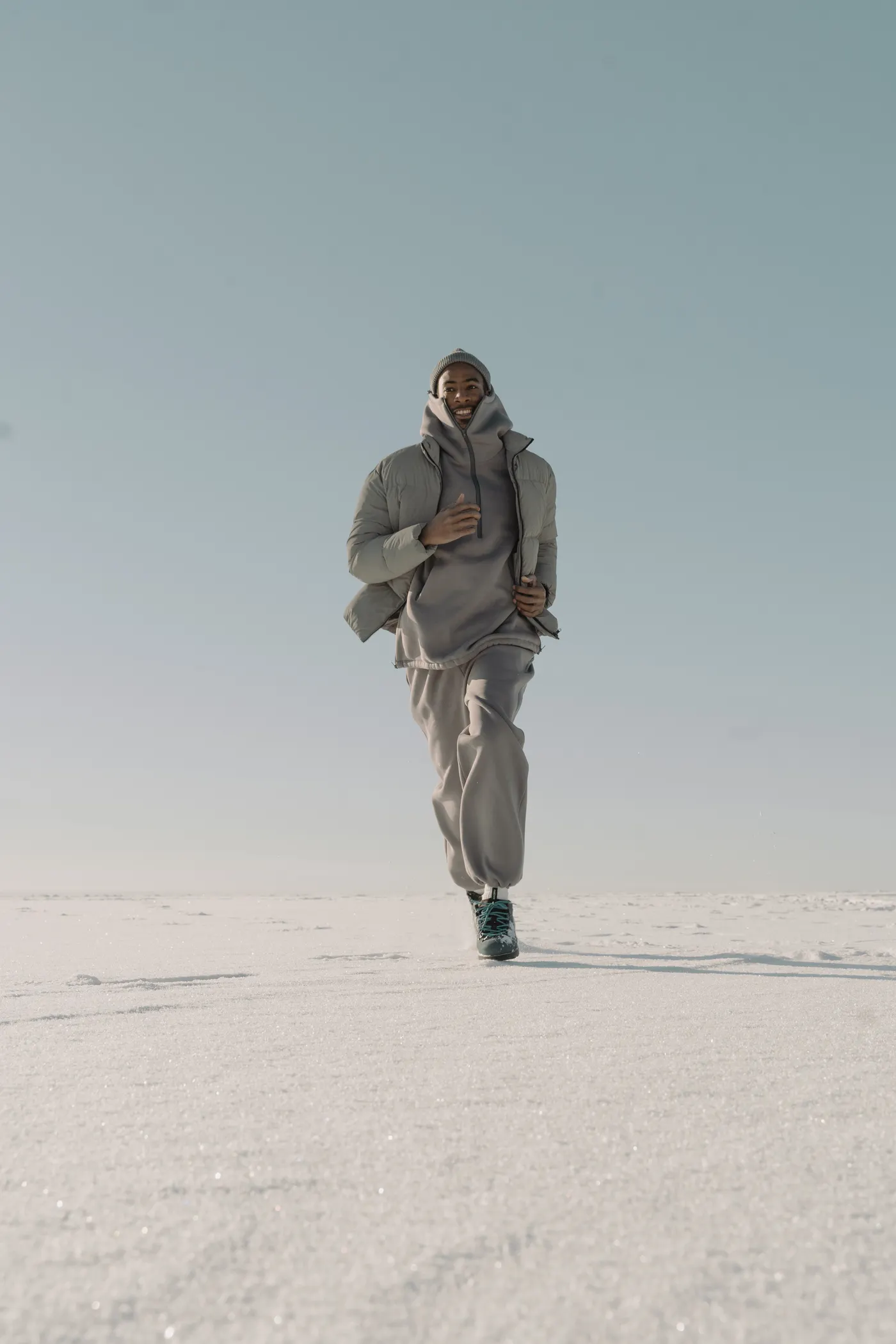 Runner wearing a warm jacket during a snowy outdoor workout