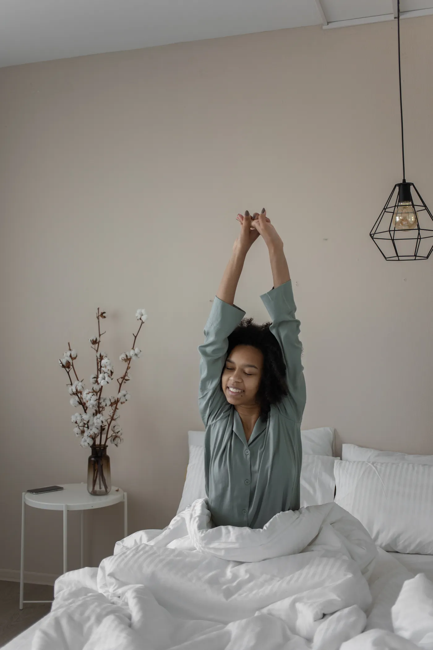 Woman stretching after waking up in bed