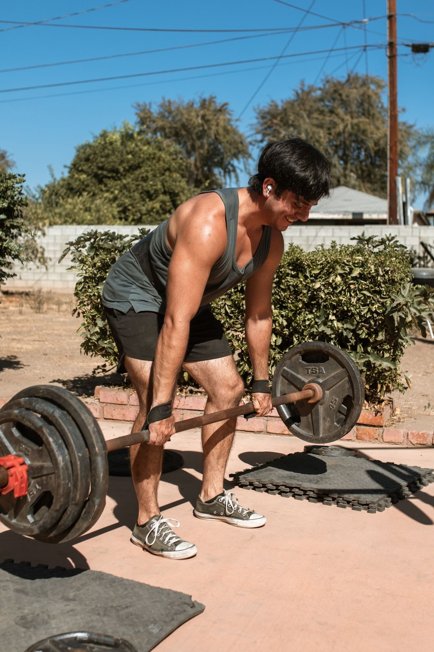 Athlete performing a heavy barbell deadlift outdoors