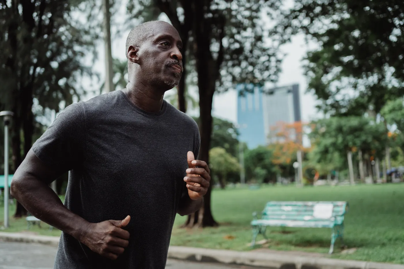 Runner moving along a green park path