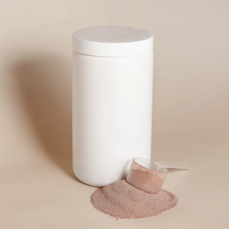 Unbranded powdered supplement and measuring scoop on a light surface