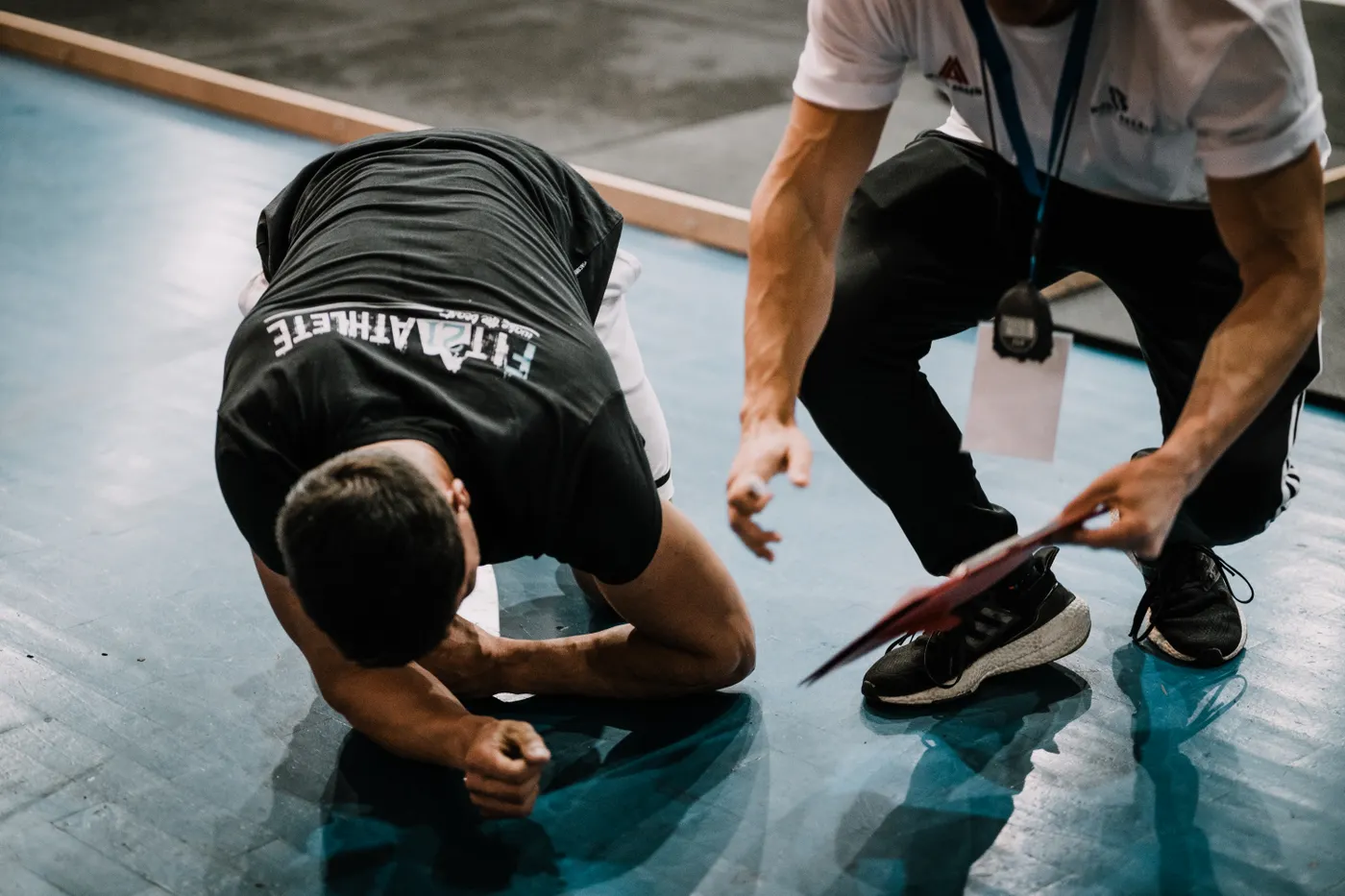 Fitness coach guiding an athlete during a strength-training session