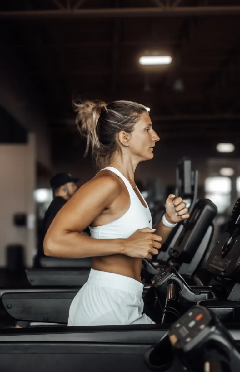 Woman running on a treadmill in a modern gym