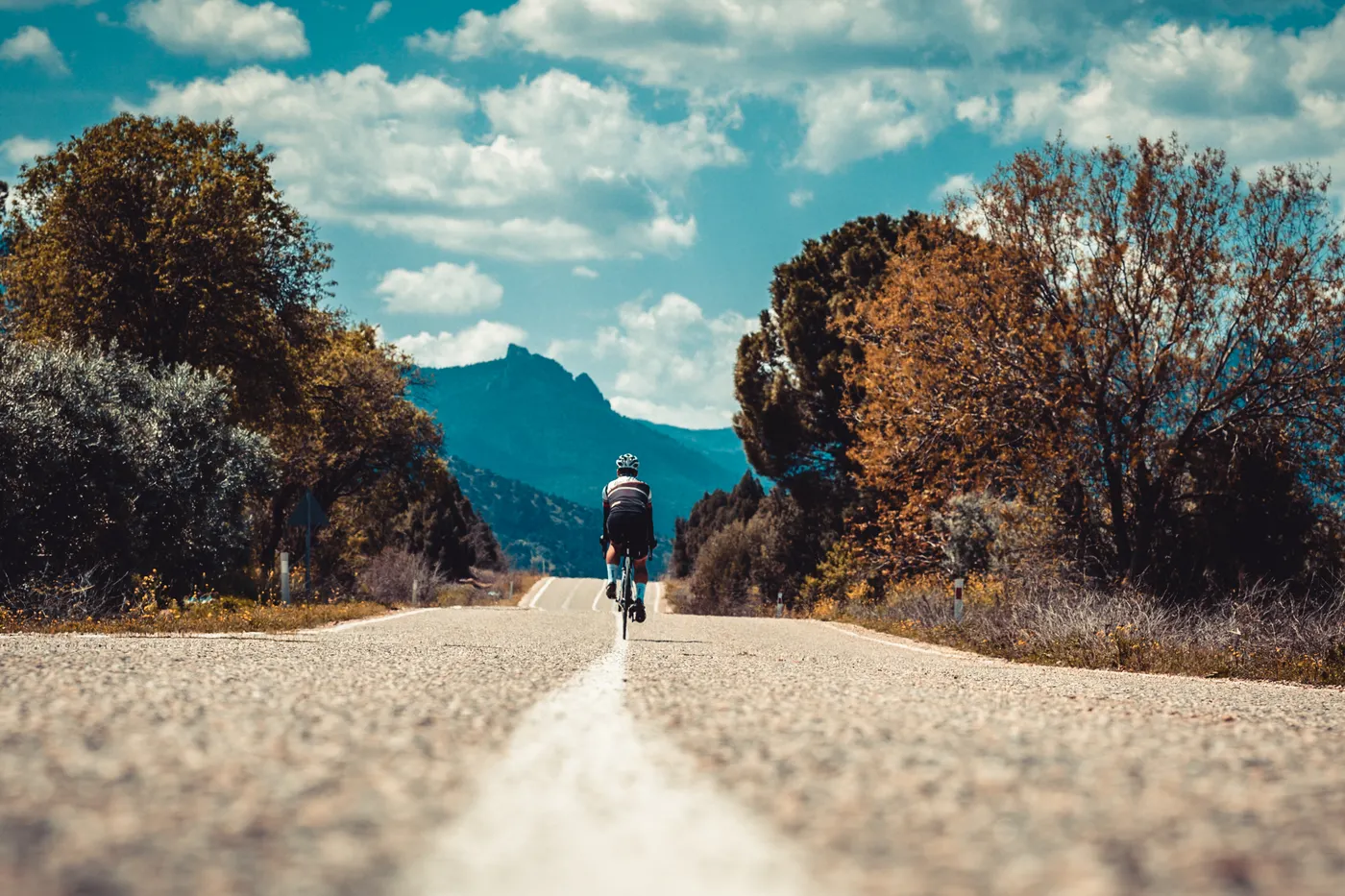Solo cyclist on a winding mountain road