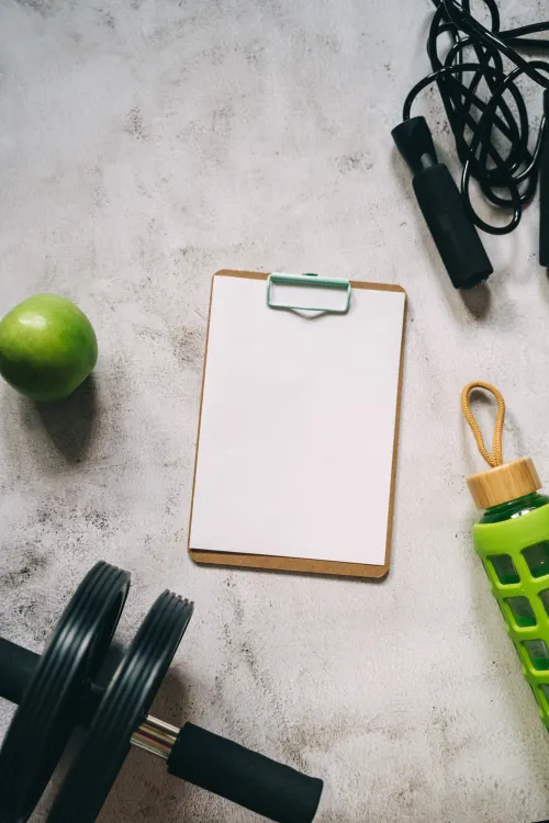 Clipboard and exercise equipment arranged for a planned workout