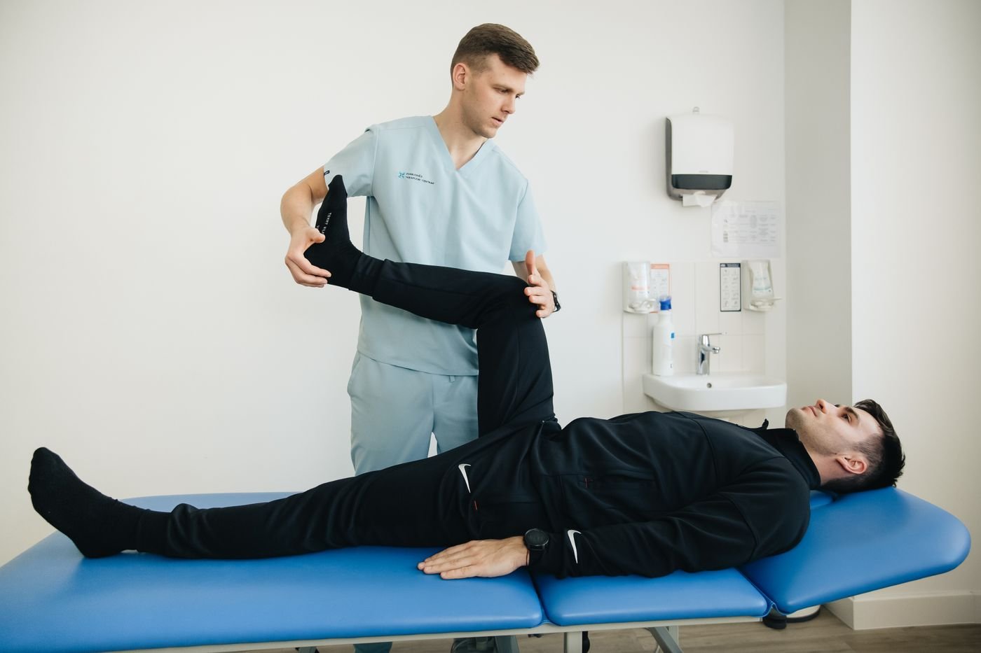 Physiotherapist assisting a patient with leg exercises