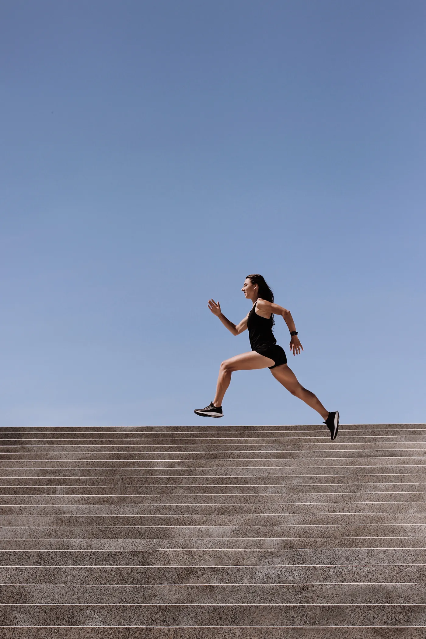 Athlete running up a set of outdoor stairs